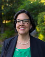 Dr. Shelley White headshot in front of trees